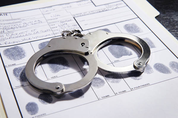 Criminal - White Collar Criminal Lawyer - handcuffs on fingerprint document