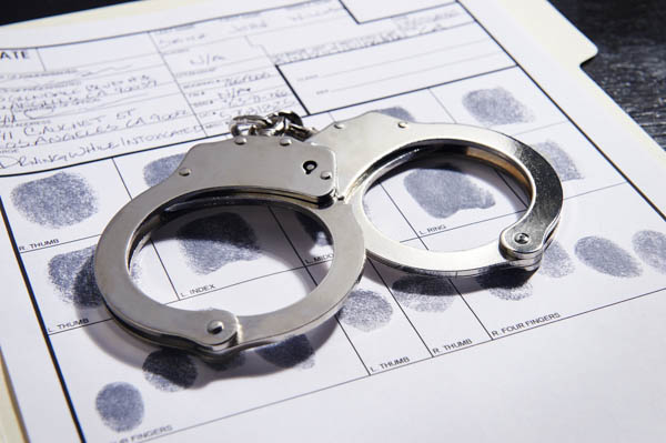 Criminal - White Collar Crime Law Criminal - White Collar Criminal Lawyer - handcuffs on fingerprint document